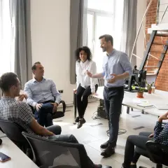 A team discusses strategy, perhaps outlining the chief strategy officer job description.