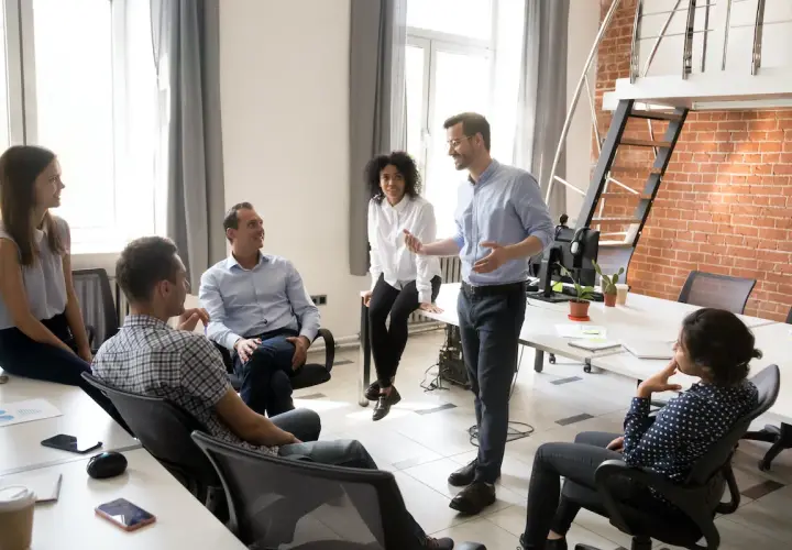 A team discusses strategy, perhaps outlining the chief strategy officer job description.