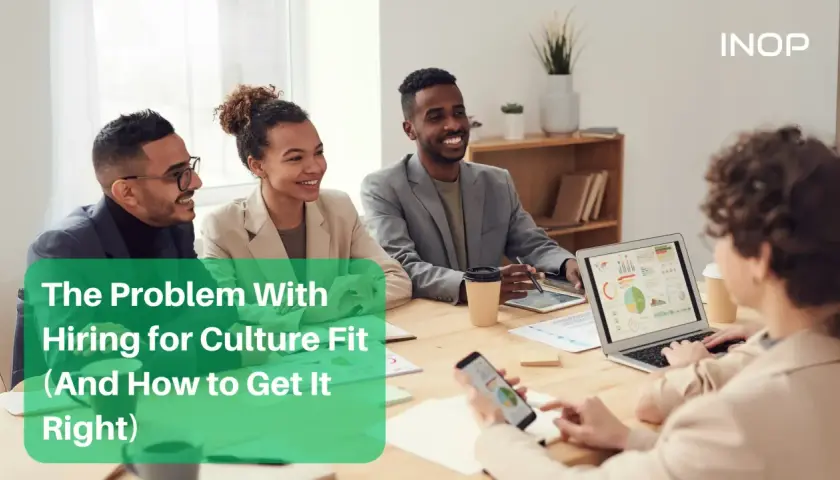 Diverse team in a meeting discussing hiring for culture fit.