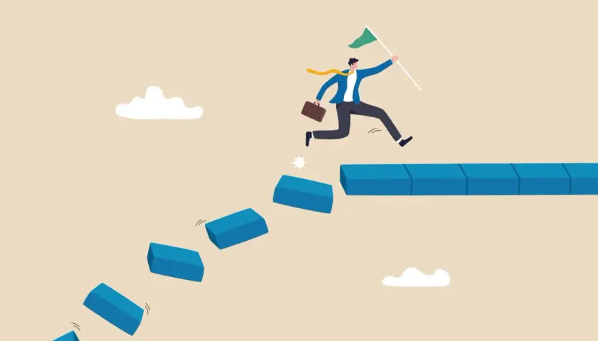 A businessman leaps across broken steps, holding a flag, illustrating how to handle a crisis situation by taking bold steps towards success.