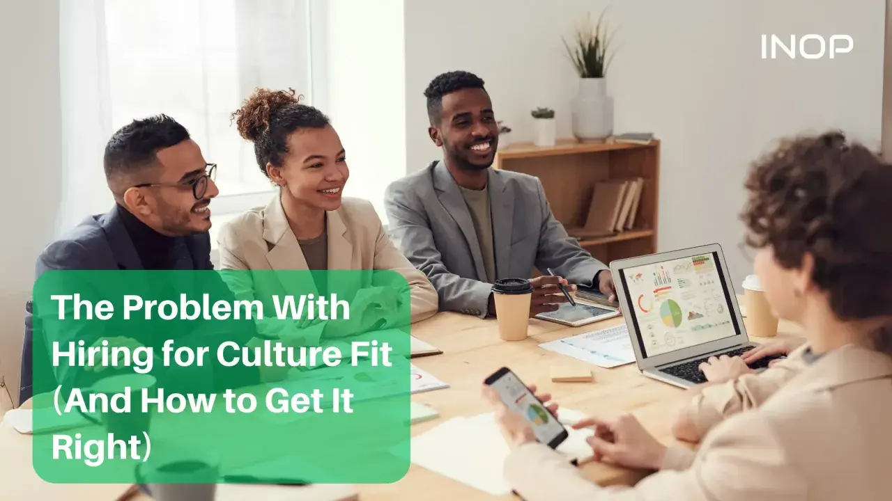 Diverse team in a meeting discussing hiring for culture fit.