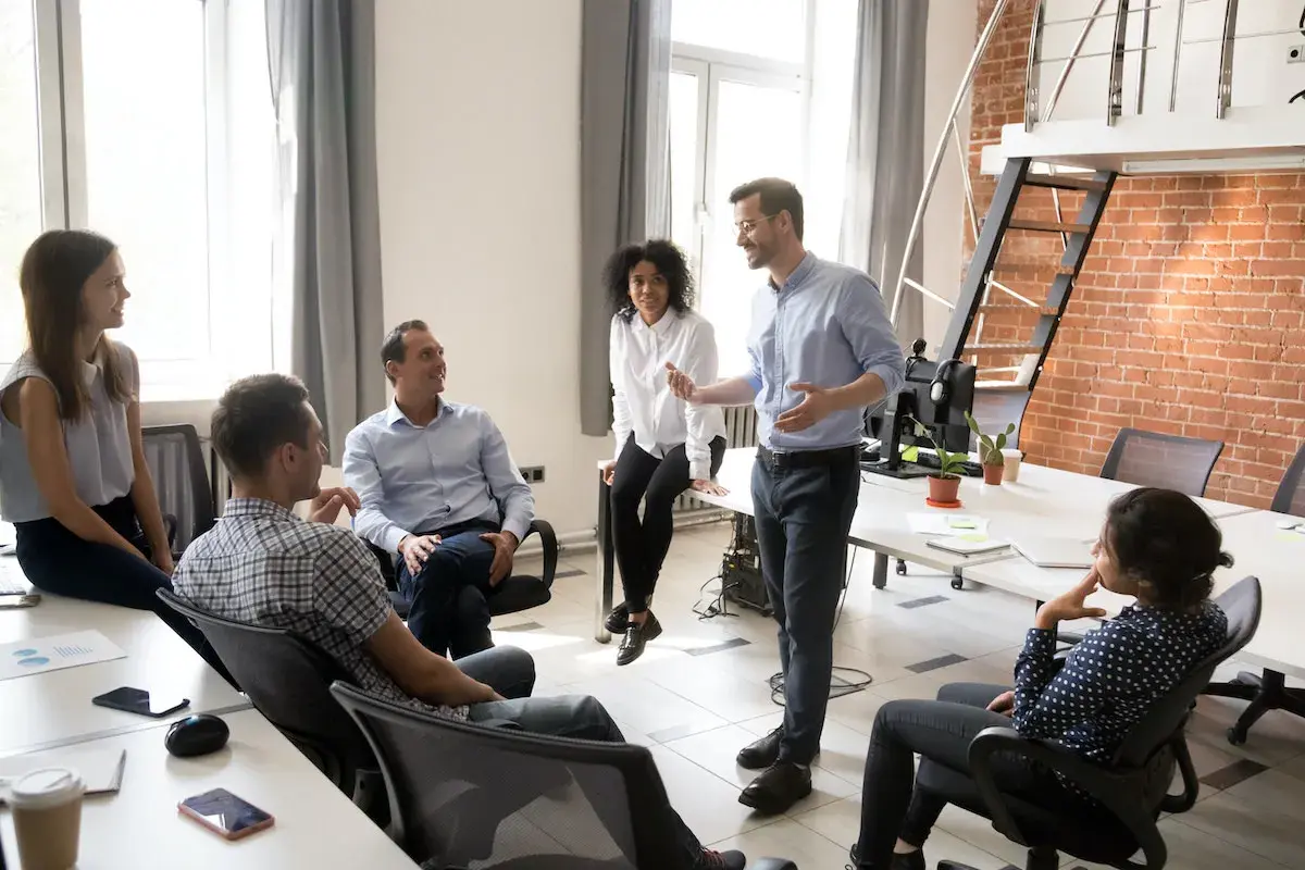 A team discusses strategy, perhaps outlining the chief strategy officer job description.