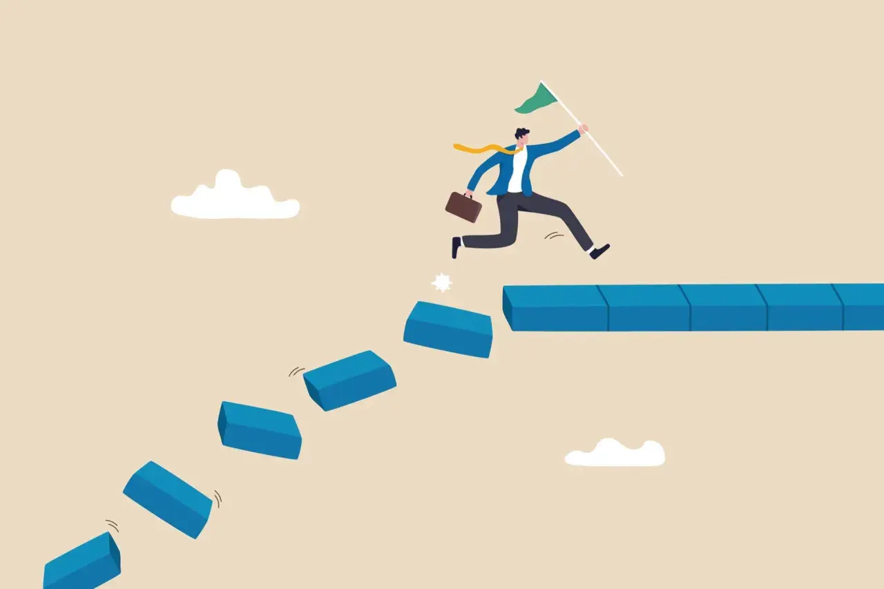 A businessman leaps across broken steps, holding a flag, illustrating how to handle a crisis situation by taking bold steps towards success.