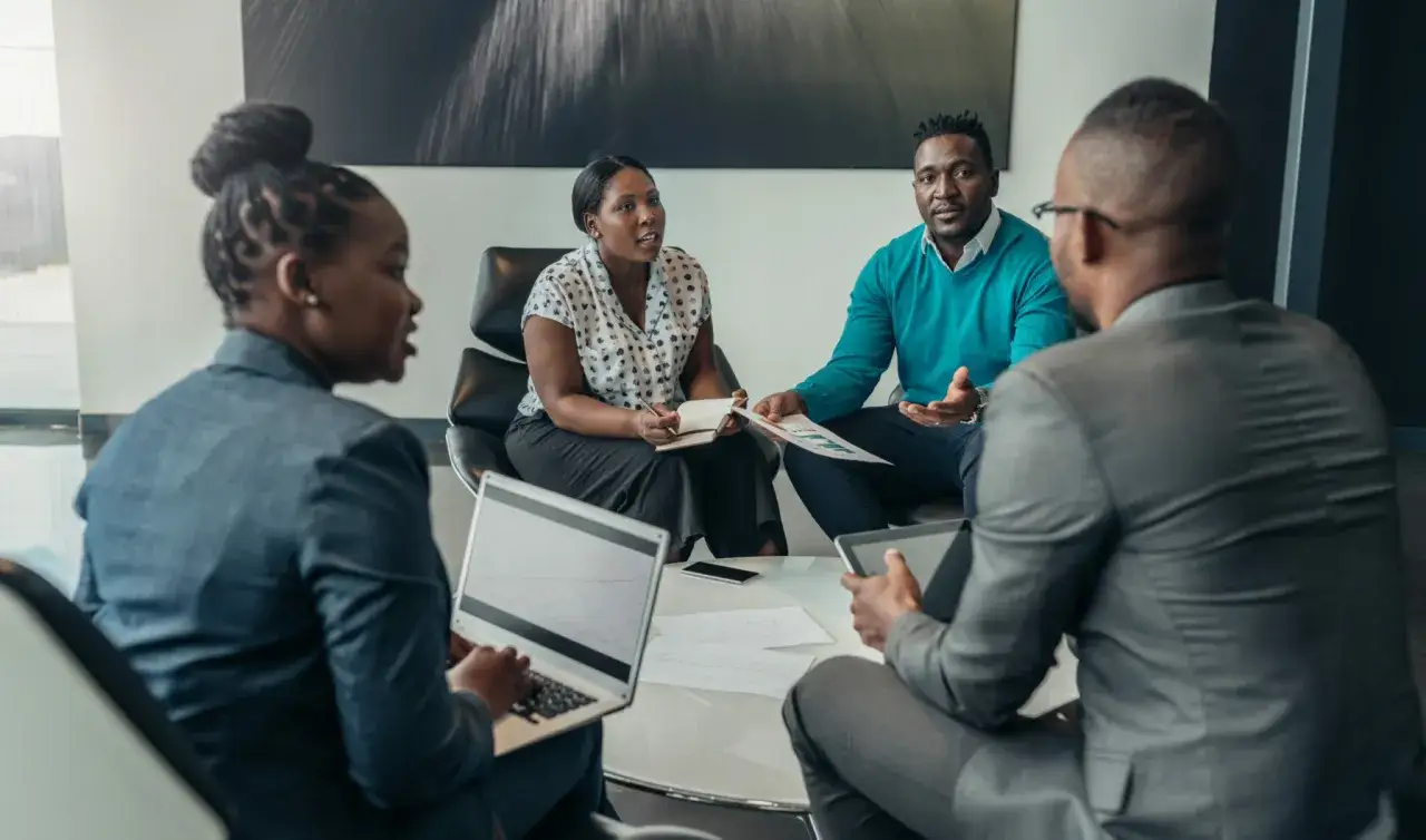 Diverse team in a meeting, discussing strategies. This scene could be part of board of directors training programs, focusing on collaboration and decision-making.