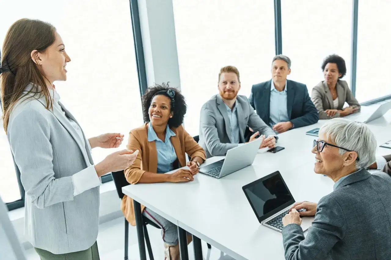A leader inspires her team. They gather, focused, ready to innovate and conquer.