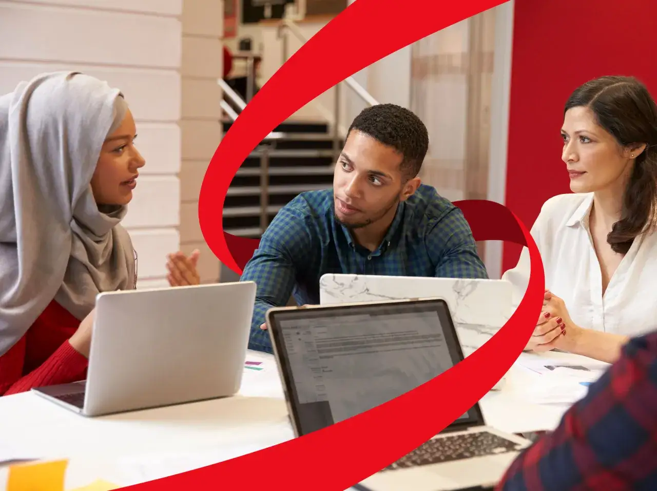 Diverse team in a meeting, discussing ideas and receiving feedback during training.