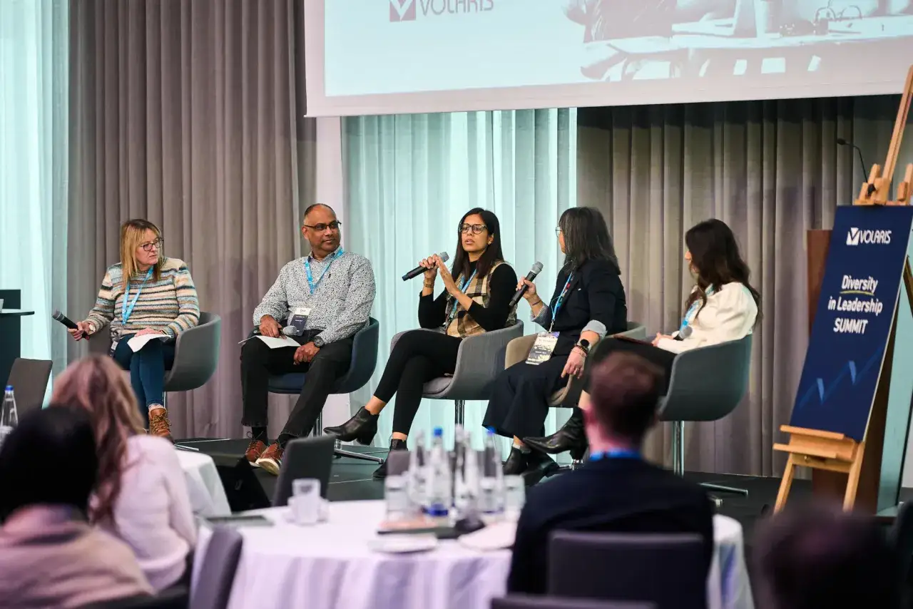 Panelists engage in discussion at a Diversity in Leadership Summit, sharing insights and fostering dialogue.